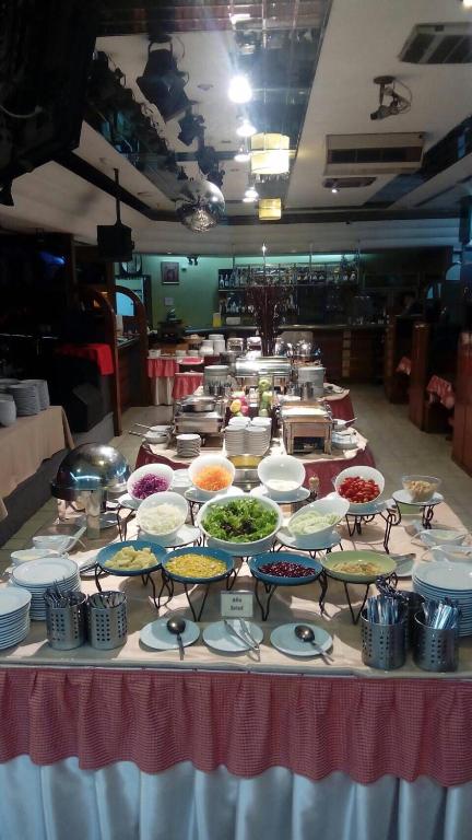 A buffet station offering bowls of toppings, salads and chilled dishes.