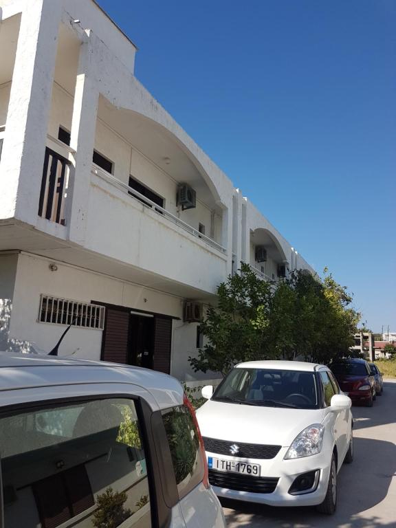 two cars parked in front of a building at Thalassa Studios in Faliraki