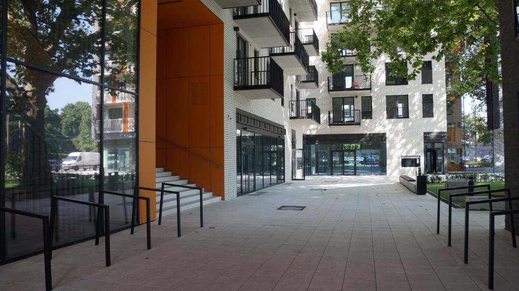 an empty sidewalk in front of a building at Art Apartments in Wrocław