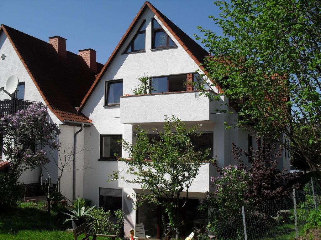 a white house with a black roof at Ferienhaus am Schönberg in Schauenburg