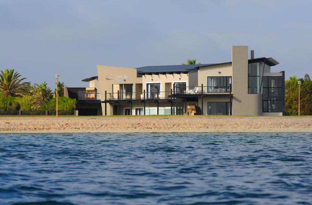 a house on the beach next to the water at Oyster Box Guesthouse in Walvis Bay