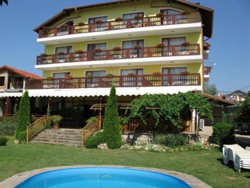 a large building with a pool in front of it at Margarita Hotel in Varna City