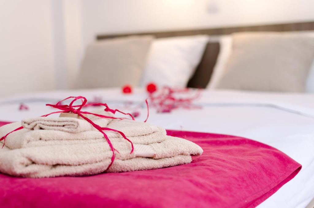 a pile of towels sitting on top of a bed at Apartments Maja in Soko Banja