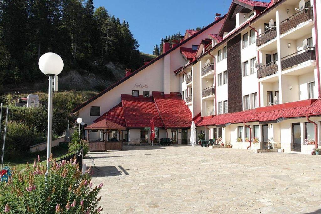 a courtyard of a building with red roofs at Christina Apartment in Laplandia in Pamporovo