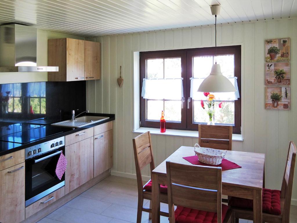 a kitchen with a table and a dining room at Landhaus Selma in Wieck
