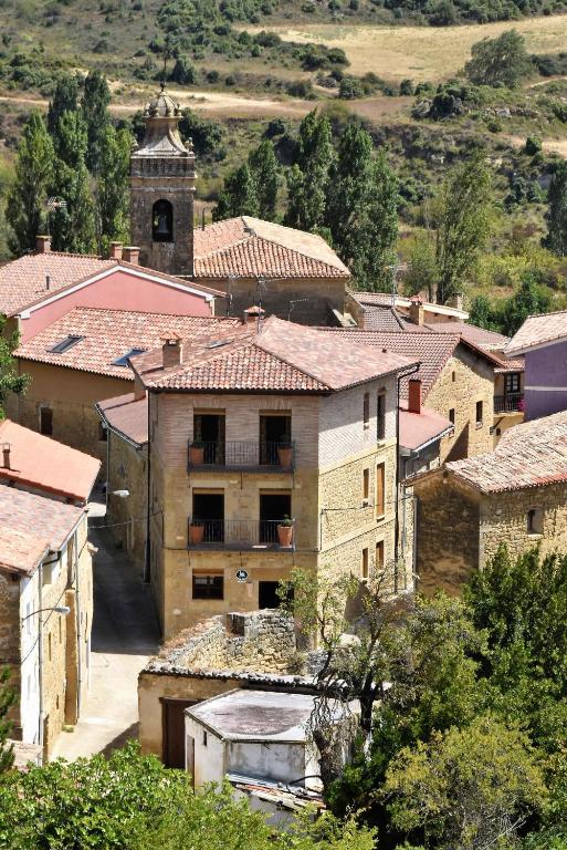 a group of buildings in a village with a clock tower at La Casa de Alberto in Ribas de Tereso