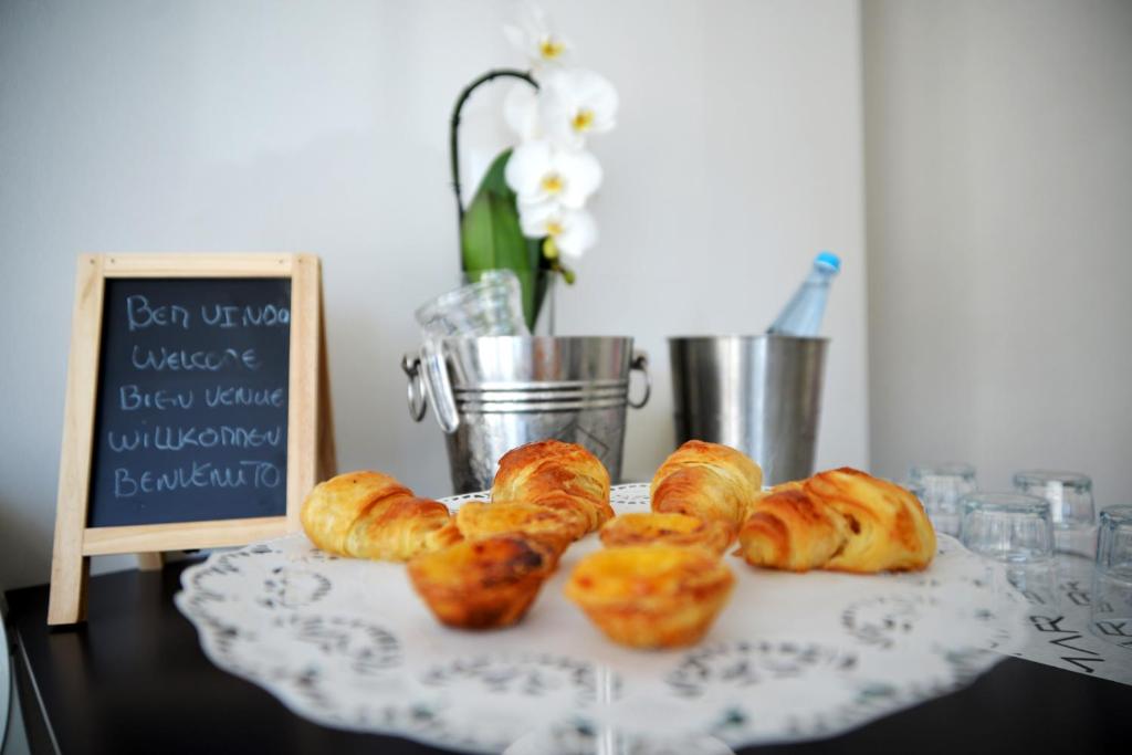 a bunch of croissants on a table with a sign at Hotel Mar Bravo in Nazaré