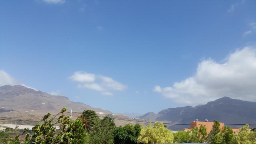 a view of mountains with a blue sky and clouds at Casa de piedra a 2 km de la Playa in La Aldea de San Nicolas