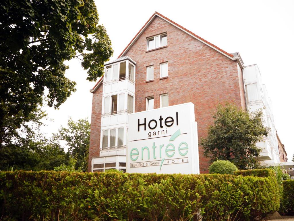 a hotel sign in front of a building at Entrée Groß Borstel Garni Hotel in Hamburg