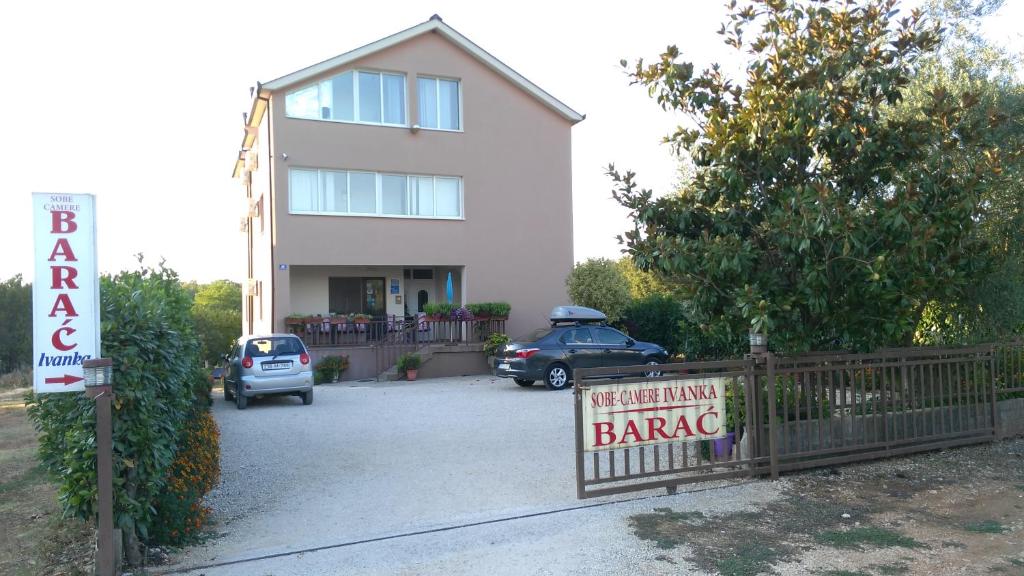 un cartello di fronte a una casa con un garage di Pansion Ivanka Barac a Međugorje