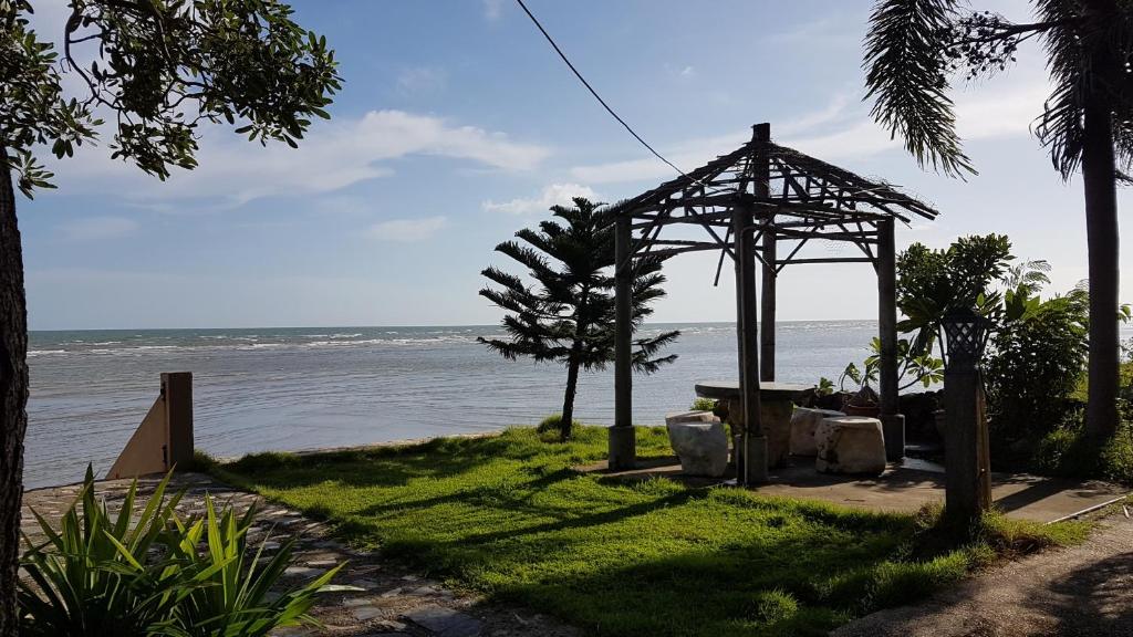 a gazebo sitting on the side of a beach at Charm de Chao Lao in Chao Lao Beach