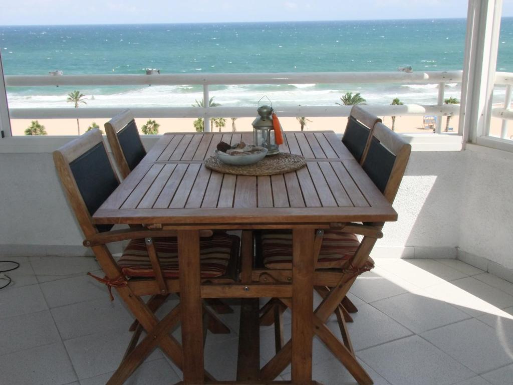a dining room table with a view of the beach at Urbanova Apartment in El Alted