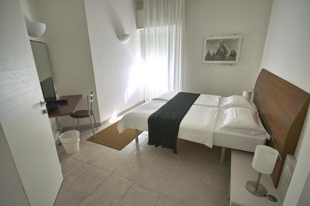 Postel nebo postele na pokoji v ubytování Hotel L'Approdo