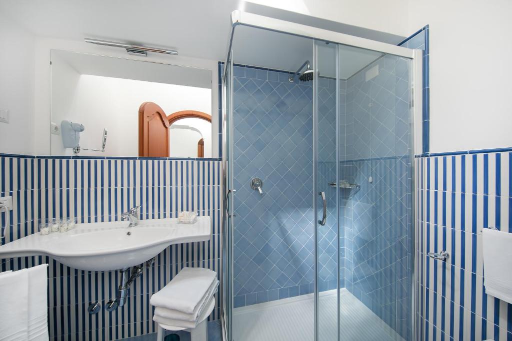 a bathroom with a sink and a shower at Hotel Pupetto in Positano