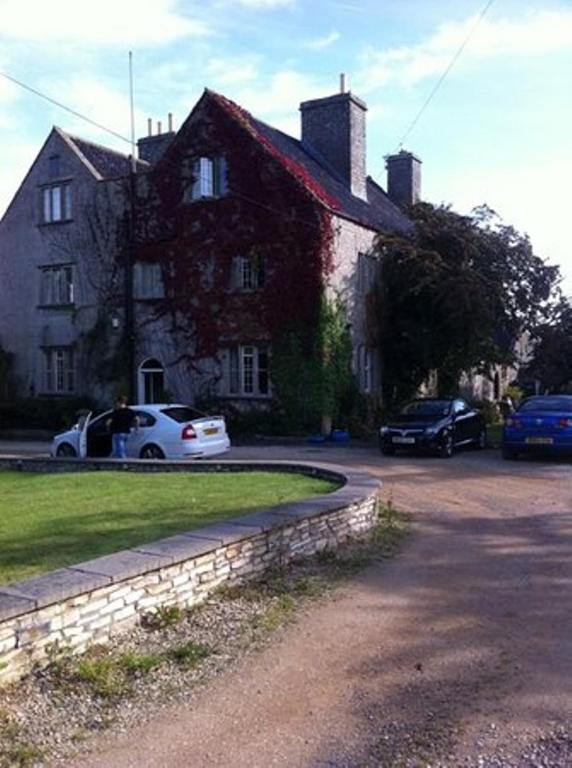 a house with two cars parked in front of it at Claridges B&B in Keynsham