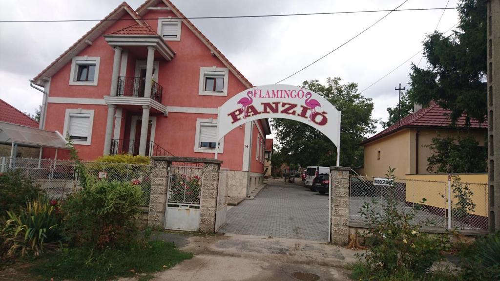 a gate to a house with a sign in front of it at Flamingó Panzió in Székesfehérvár