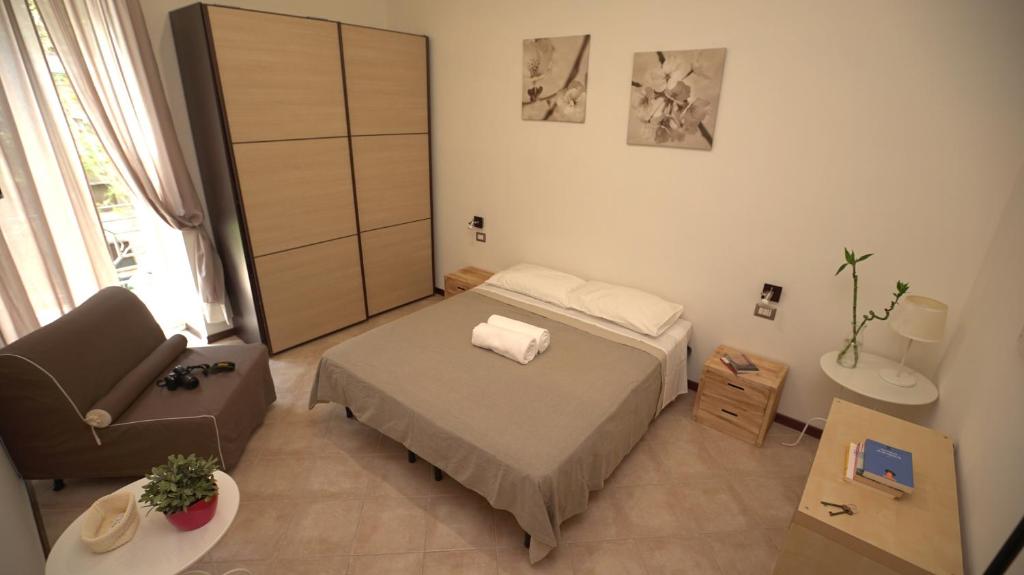 a small bedroom with a bed and a chair at Domus Amica in Rome