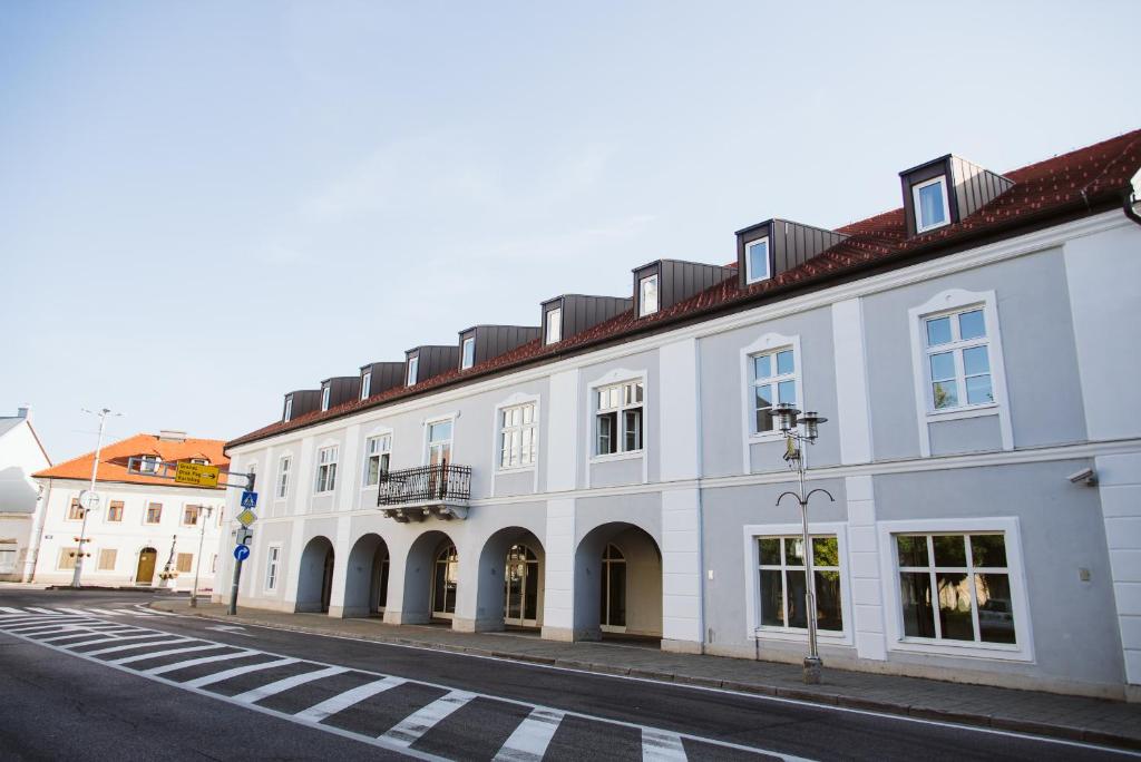 un gran edificio blanco al lado de una calle en Hotel Stara Lika en Gospić