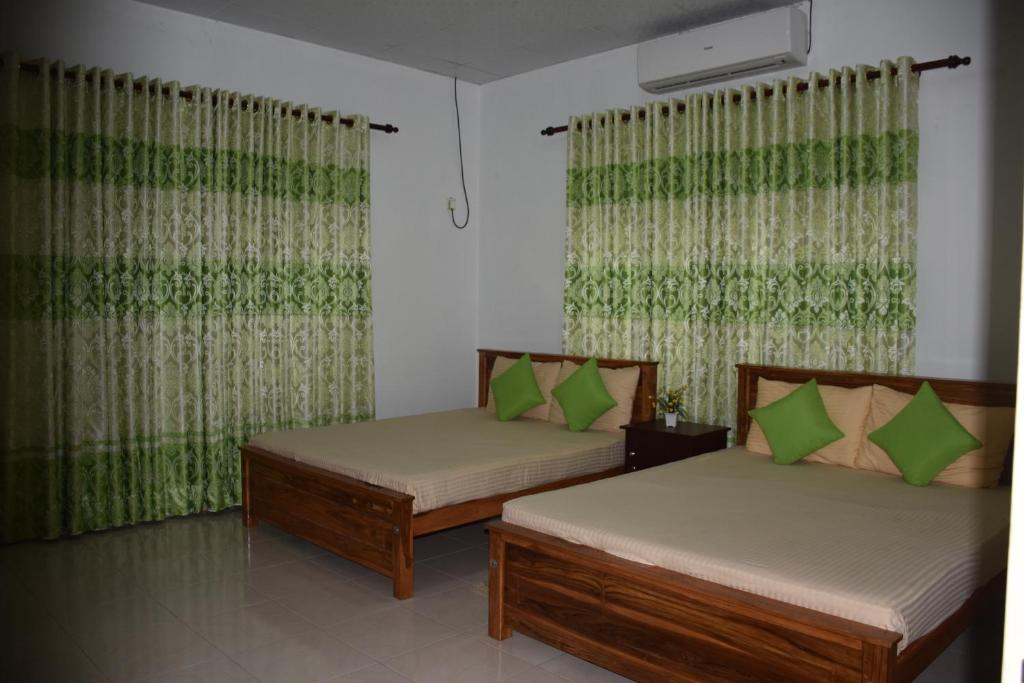 Postel nebo postele na pokoji v ubytování Green Palace Hotel