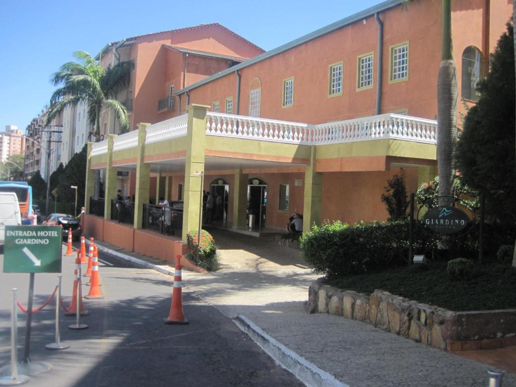 a building on a street with orange cones in front of it at Apartamento Giardino Rio Quente in Rio Quente