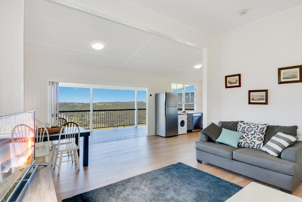 a living room with a couch and a table at Cloud Hill in Maleny