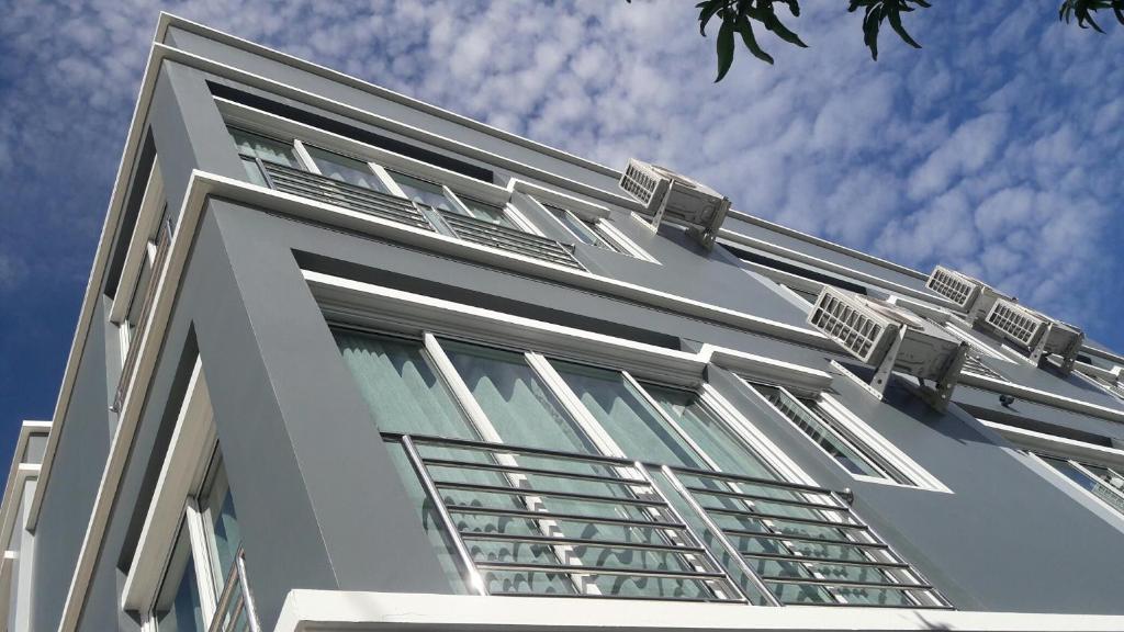 a white building with windows on the side of it at Asia's Beach Apartments in Sattahip