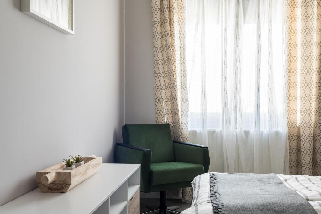 Łóżko lub łóżka w pokoju w obiekcie Csapô Apartment
