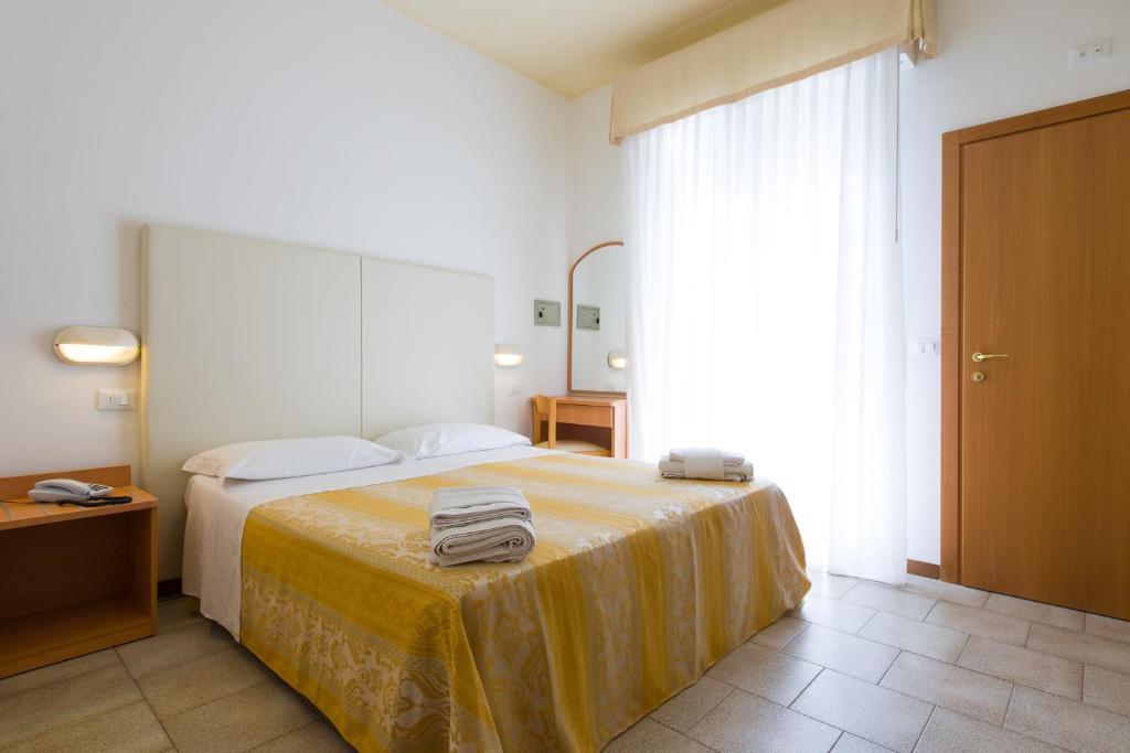 Postel nebo postele na pokoji v ubytování Hotel Galassia