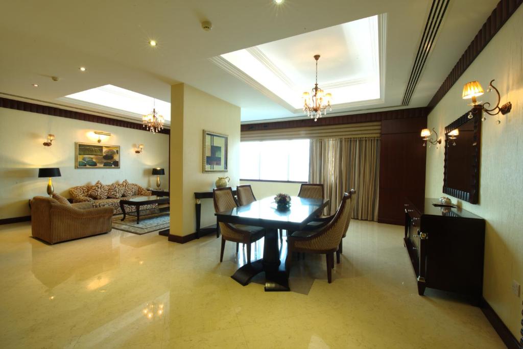 a living room with a table and a couch at Concorde Hotel Fujairah in Fujairah