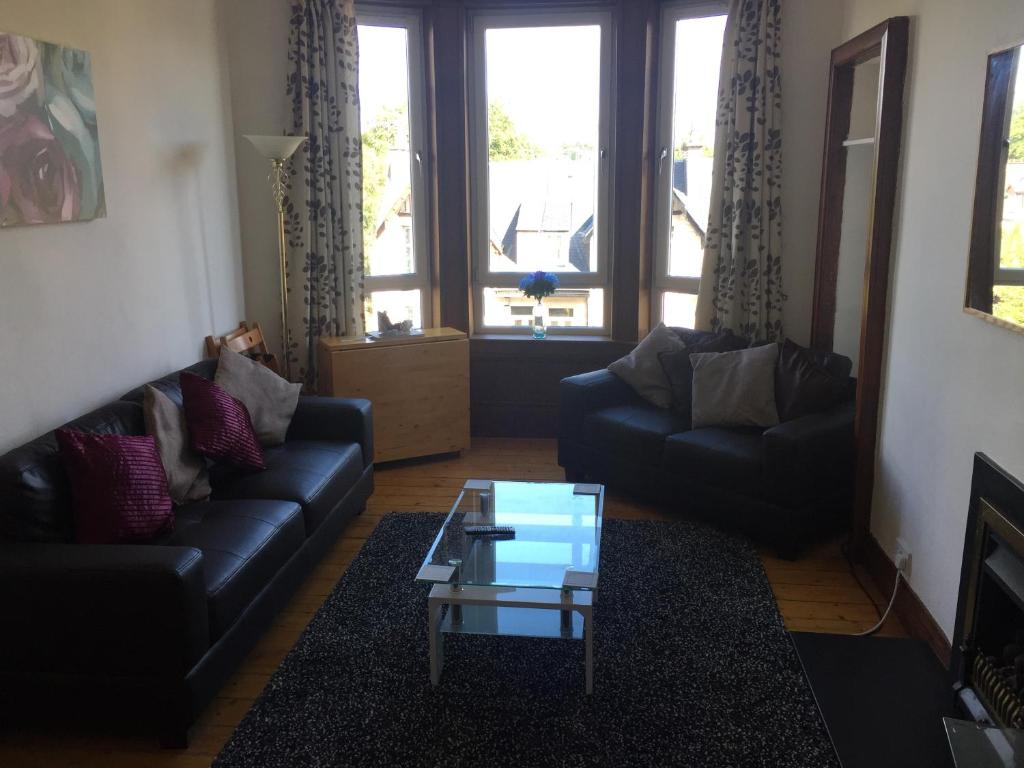 a living room with two couches and a coffee table at Scotstoun Appartments in Glasgow
