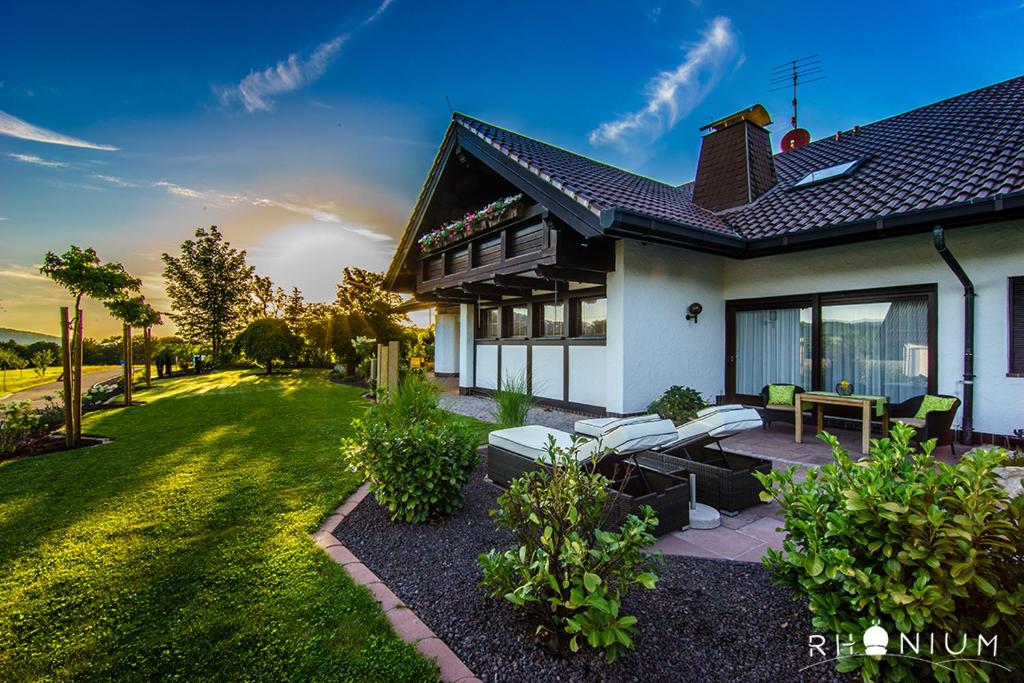 a house with a patio with a table and chairs at Landhaus Rhönium in Gersfeld