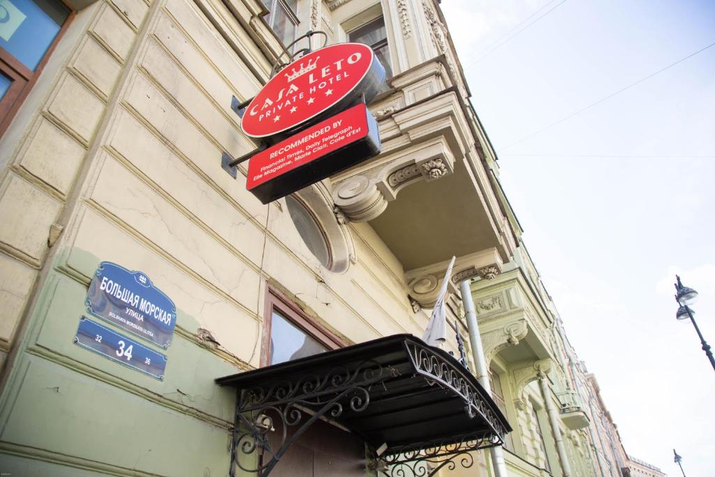 a group of signs on the side of a building at Casa Leto in Saint Petersburg
