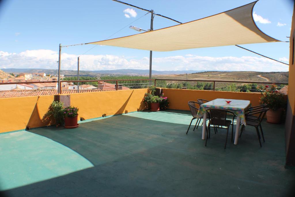 a patio with a table and chairs on a balcony at Casa Anita in Concud