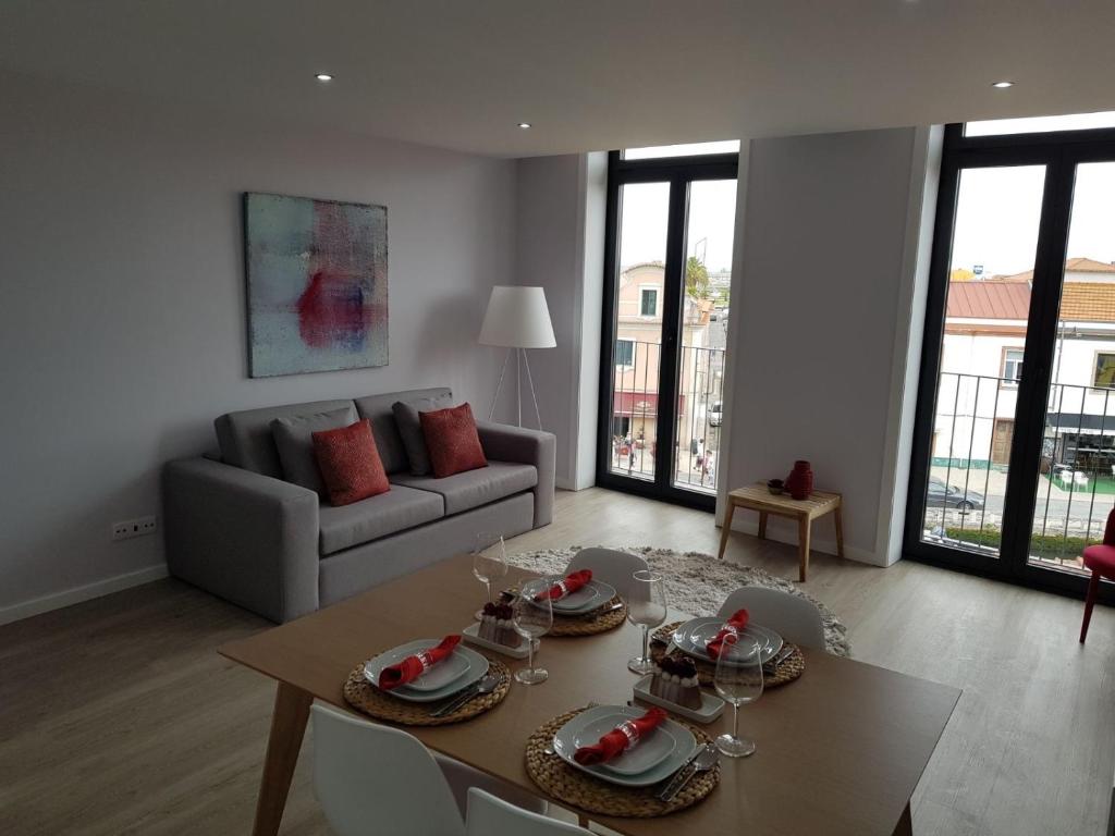a living room with a table and a couch at Innapartments São Gonçalinho II in Aveiro