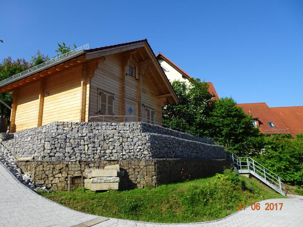 a stone retaining wall in front of a house at Ferienhaus Blick Hasserode in Wernigerode