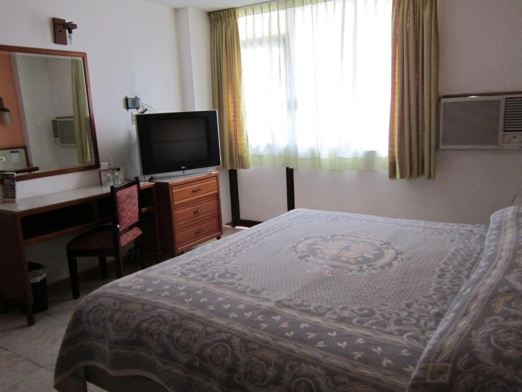 Postel nebo postele na pokoji v ubytování Hotel Baluarte
