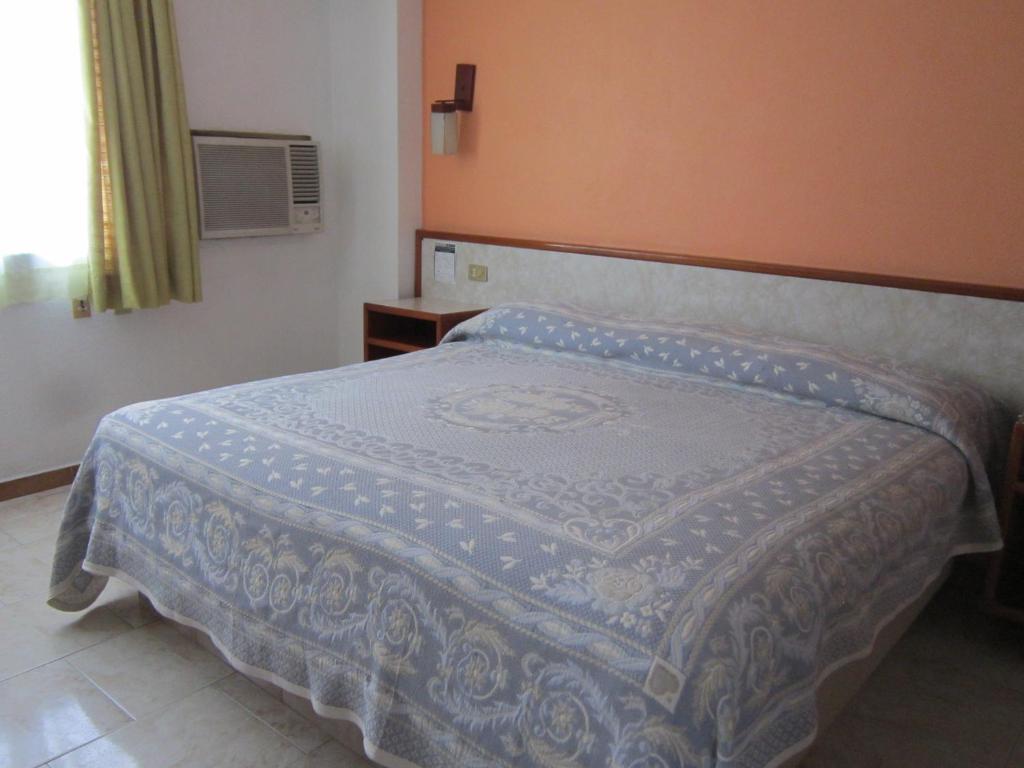 Postel nebo postele na pokoji v ubytování Hotel Baluarte