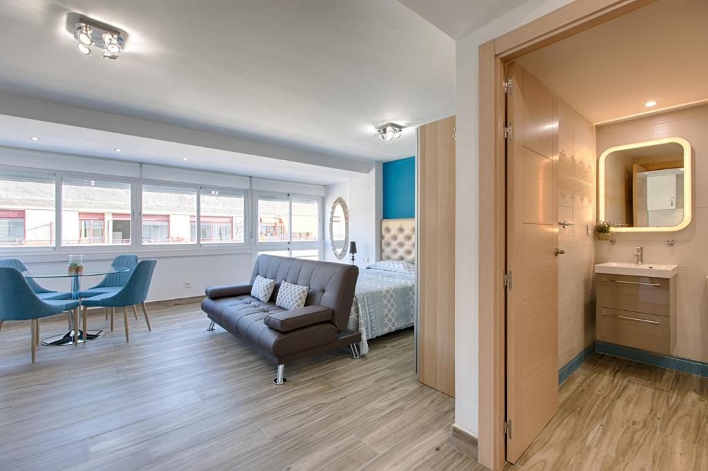 エステポナにあるEstepona Real Classic Apartamentoのベッドルーム1室(ベッド1台、ソファ、テーブル付)
