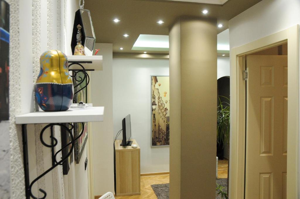 einen Flur mit einer Tür und einer Vase auf einem Regal in der Unterkunft Apartment D-22 in Belgrad