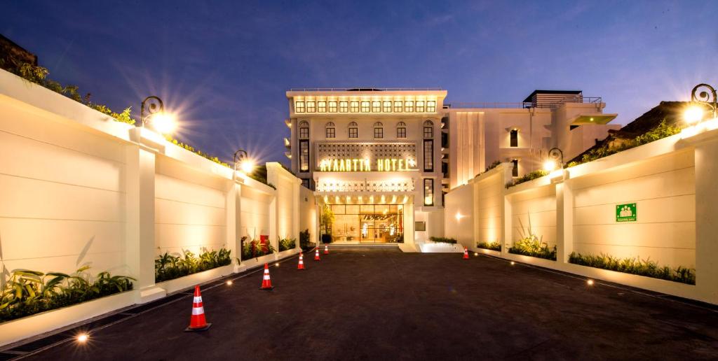 a large building with orange cones in front of it at Ayaartta Hotel Malioboro in Yogyakarta