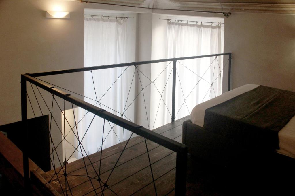A bed or beds in a room at Charming Genova | Residenza d'epoca
