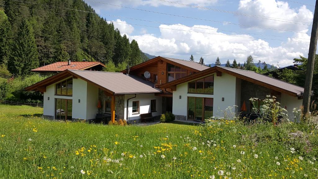 a house in the middle of a field of flowers at Zugspitzchalets in Biberwier