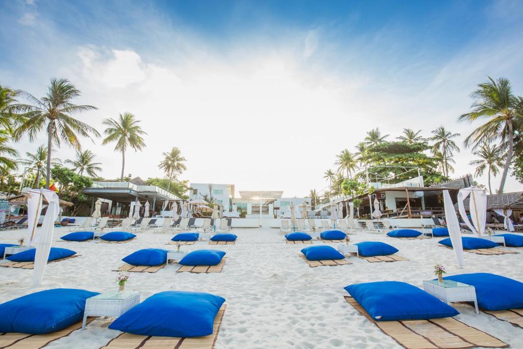 a group of chairs and umbrellas on a beach at KC Beach Club & Pool Villas in Chaweng
