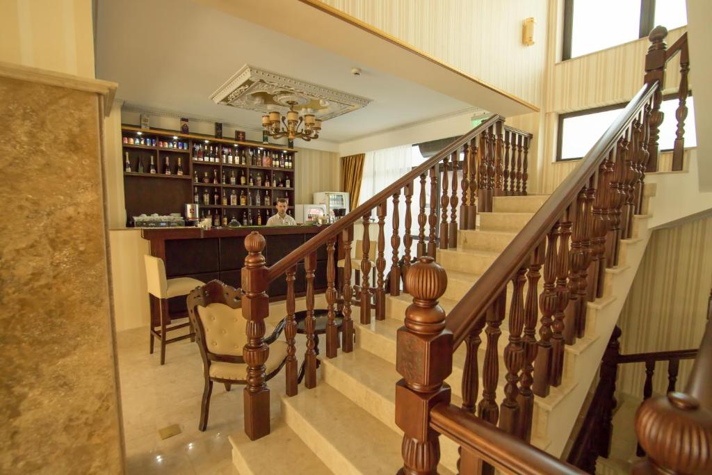 a staircase in a home with a bar in the background at MSR Port Hotel in Mangalia