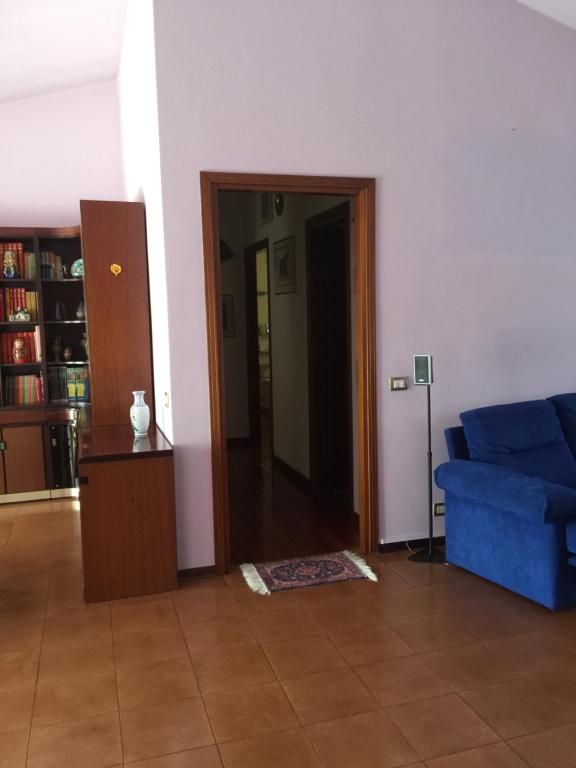 ein Wohnzimmer mit einem blauen Sofa und einer Tür in der Unterkunft Milan in Vittuone