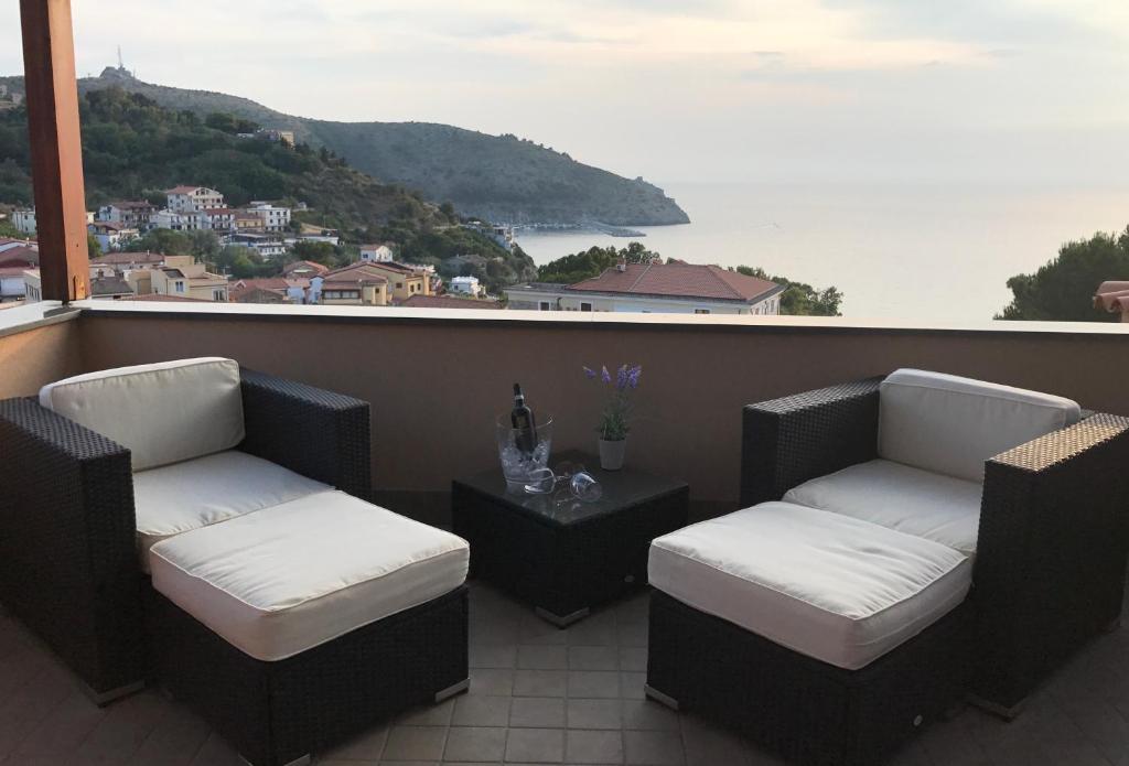 a balcony with two chairs and a table with a view at Meublé Leonetti in Palinuro