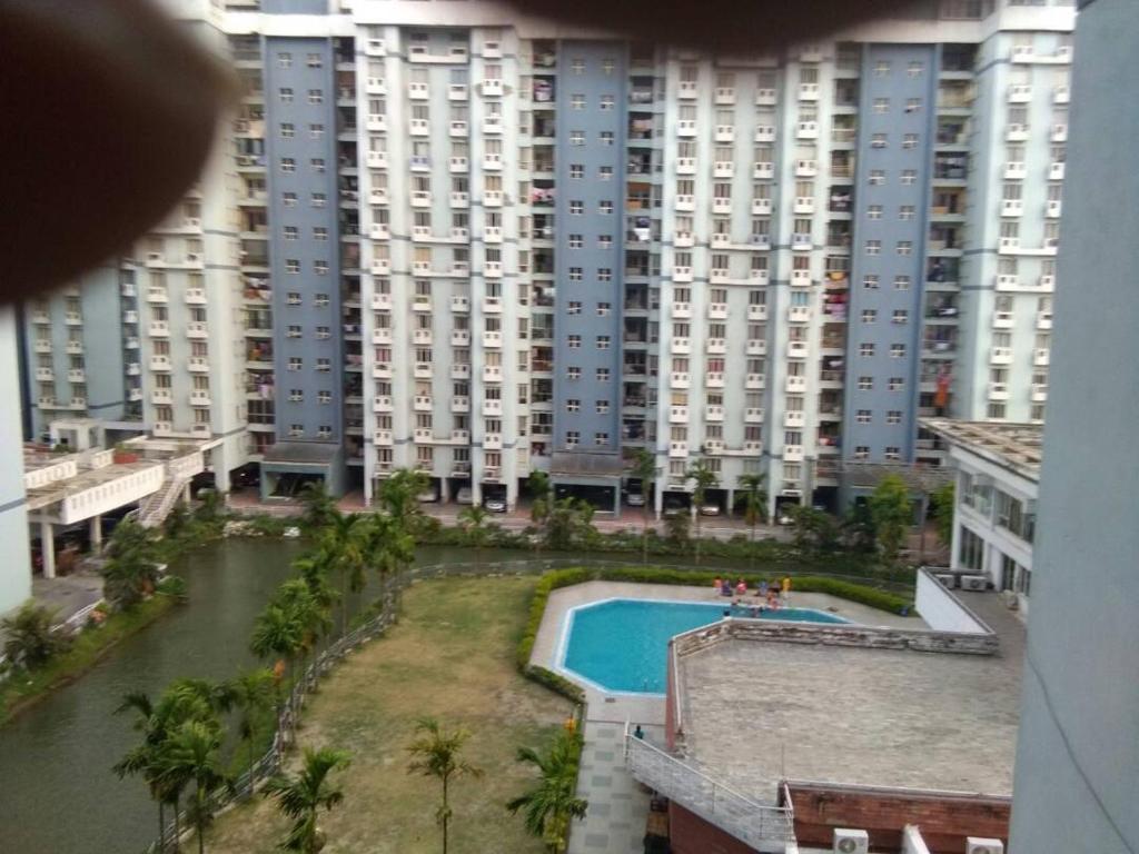 vistas a un gran edificio de apartamentos con piscina en Joy's Nest, en Calcuta