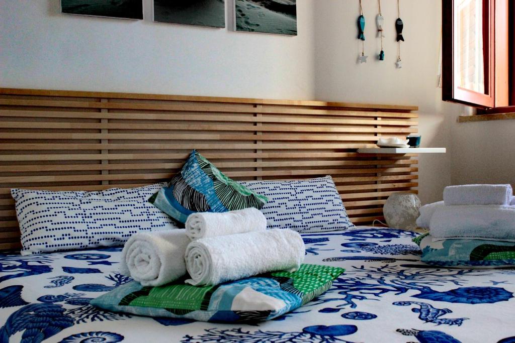a bedroom with a bed with towels on it at Casa vacanze Romax San Vito Lo Capo in San Vito lo Capo