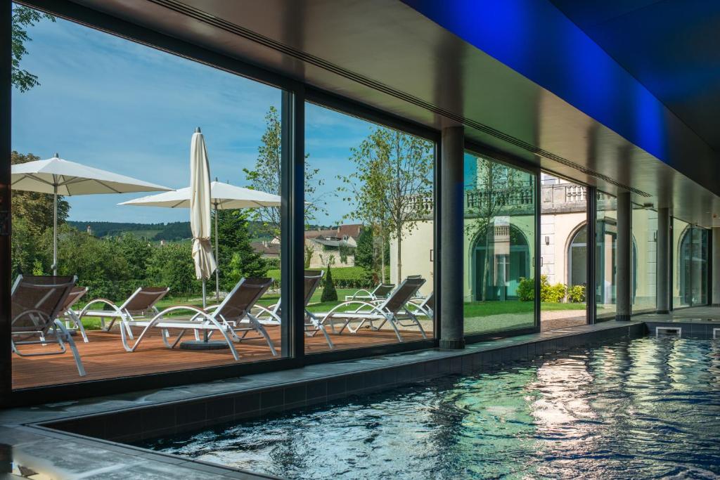a patio with a view of the water at Hôtel Spa La Cueillette in Meursault