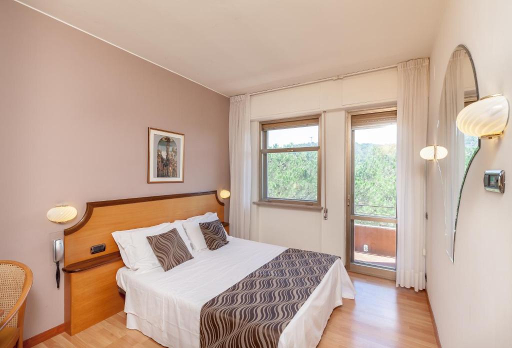 Postel nebo postele na pokoji v ubytování Hotel Tevere Perugia